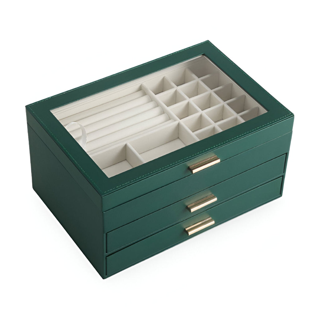 Boîte à bijoux nomade grande taille verte avec tiroirs multiples et compartiments variés sous couvercle transparent.