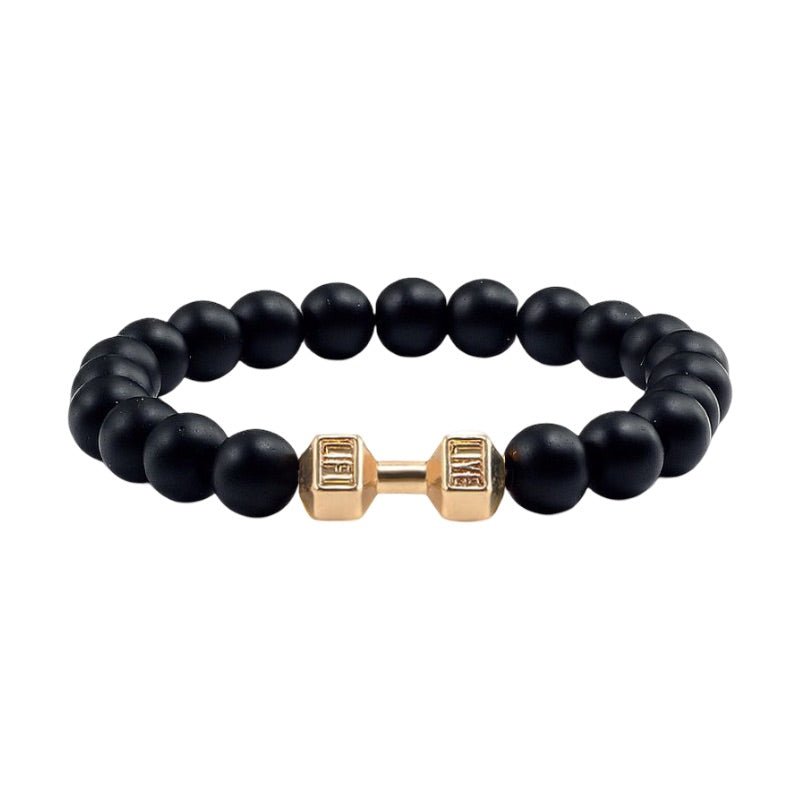 Bracelet perles noires mates avec haltère dorée centrale en acier, style musculation.