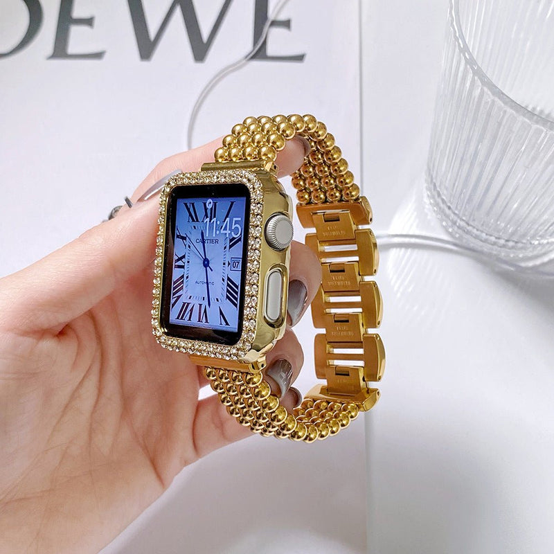 Bracelet Apple Watch en acier inoxydable doré avec perles métalliques et fermoir cliquet sécurisé, design élégant et raffiné.