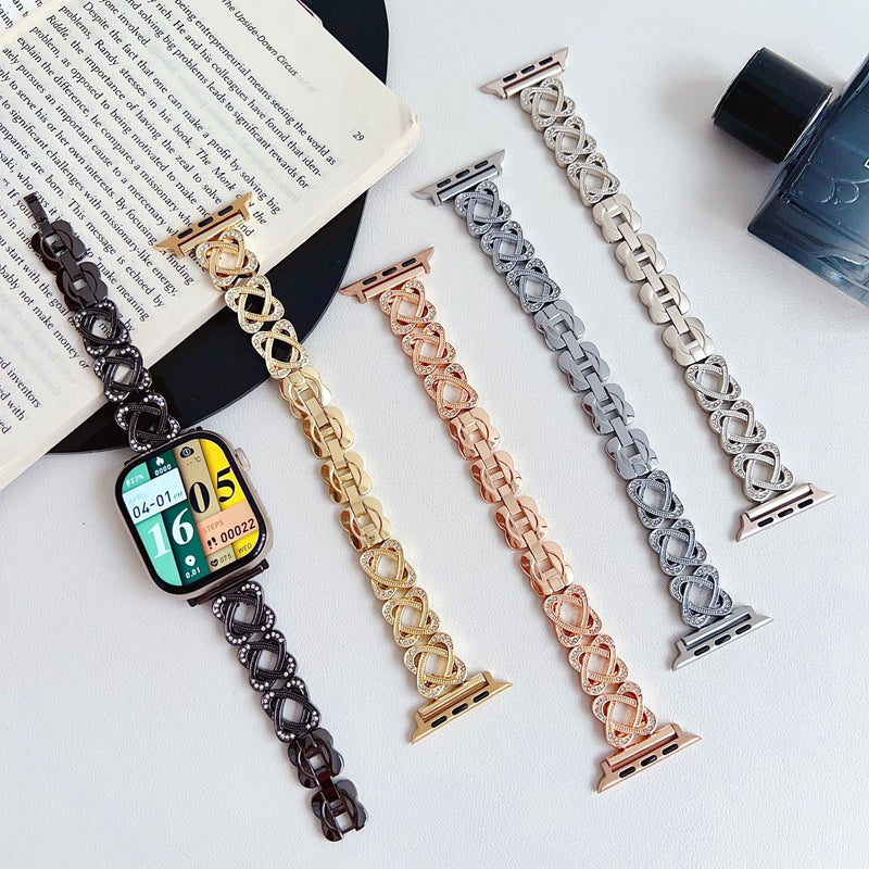 Pulseira para Apple Watch em metal prateado com malhas entrelaçadas, motivo de nó infinito cravejado de zircónias, fecho de encaixe ajustável, modelo Zergone