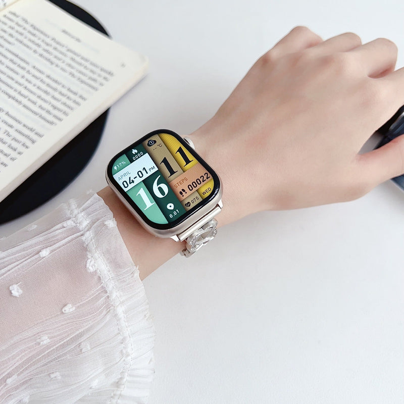 Pulseira para Apple Watch em metal prateado com malhas entrelaçadas, motivo de nó infinito cravejado de zircónias, fecho de encaixe ajustável, modelo Zergone