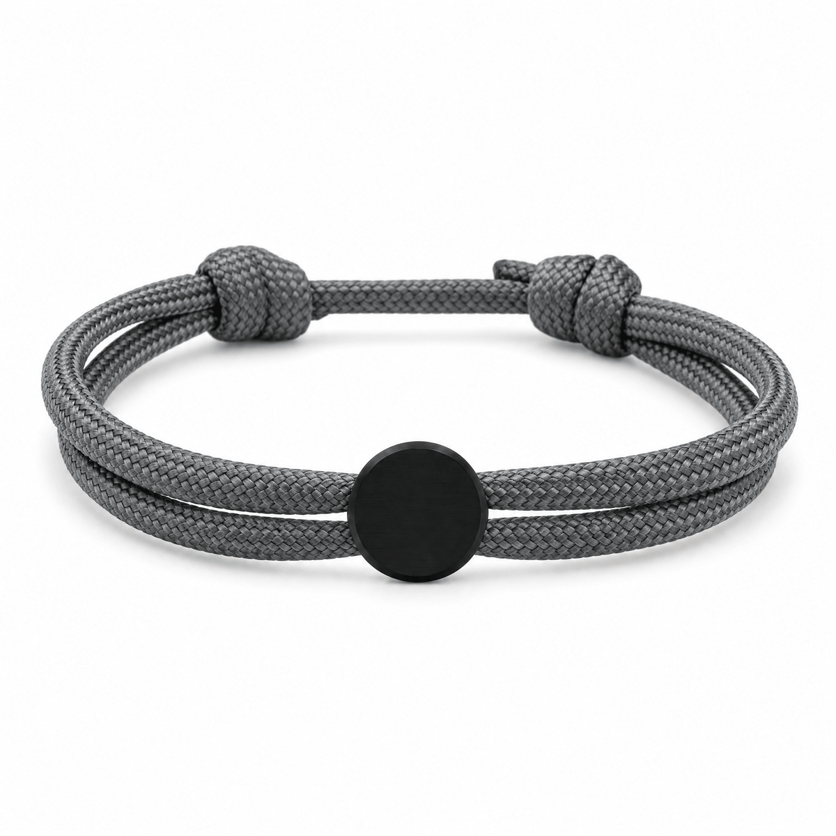 Bracelet Marsin Gris et noir, cordon ajustable et pastille ronde, posé de face sur fond blanc