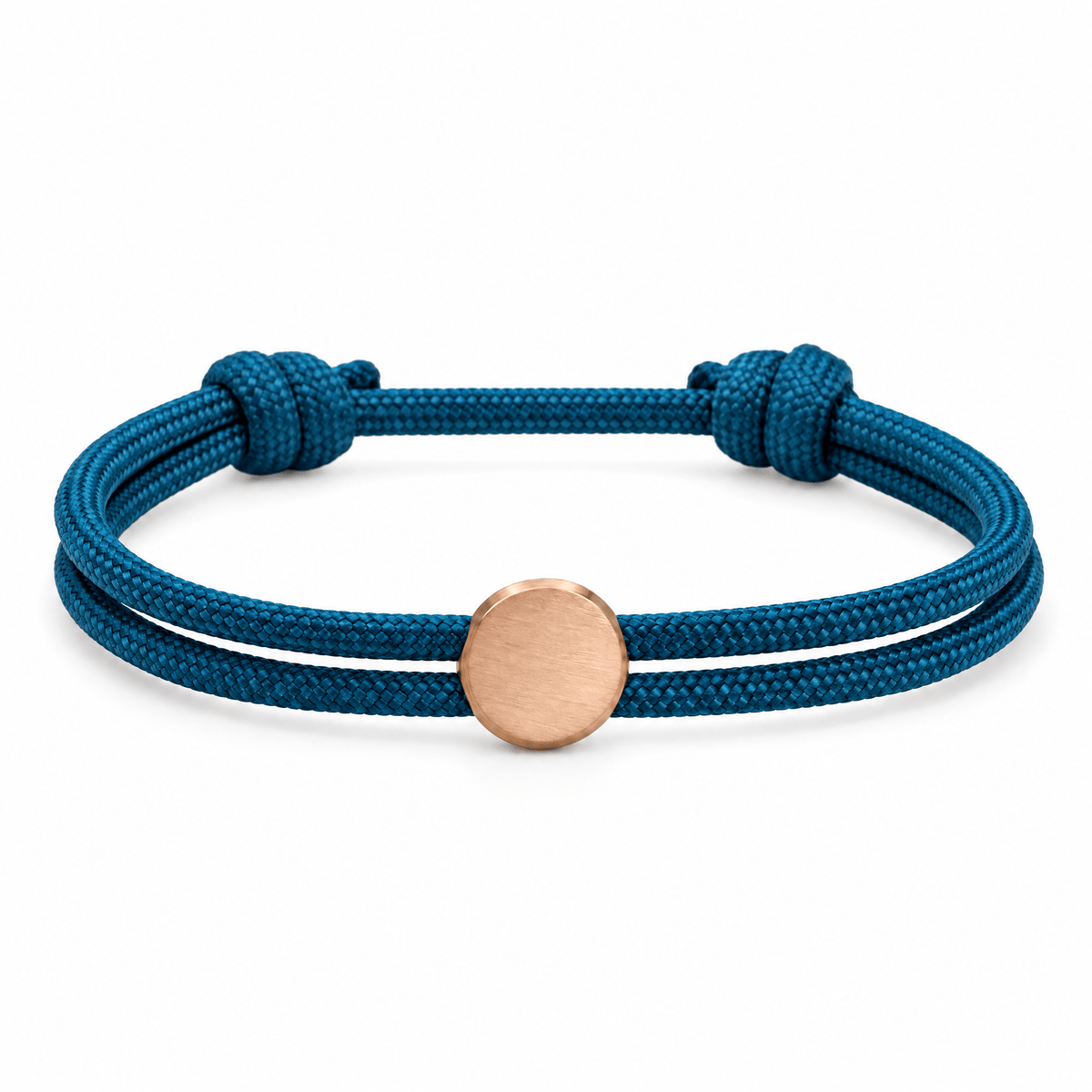 Bracelet Marsin Bleu et or rosé, cordon ajustable et pastille ronde, posé de face sur fond blanc