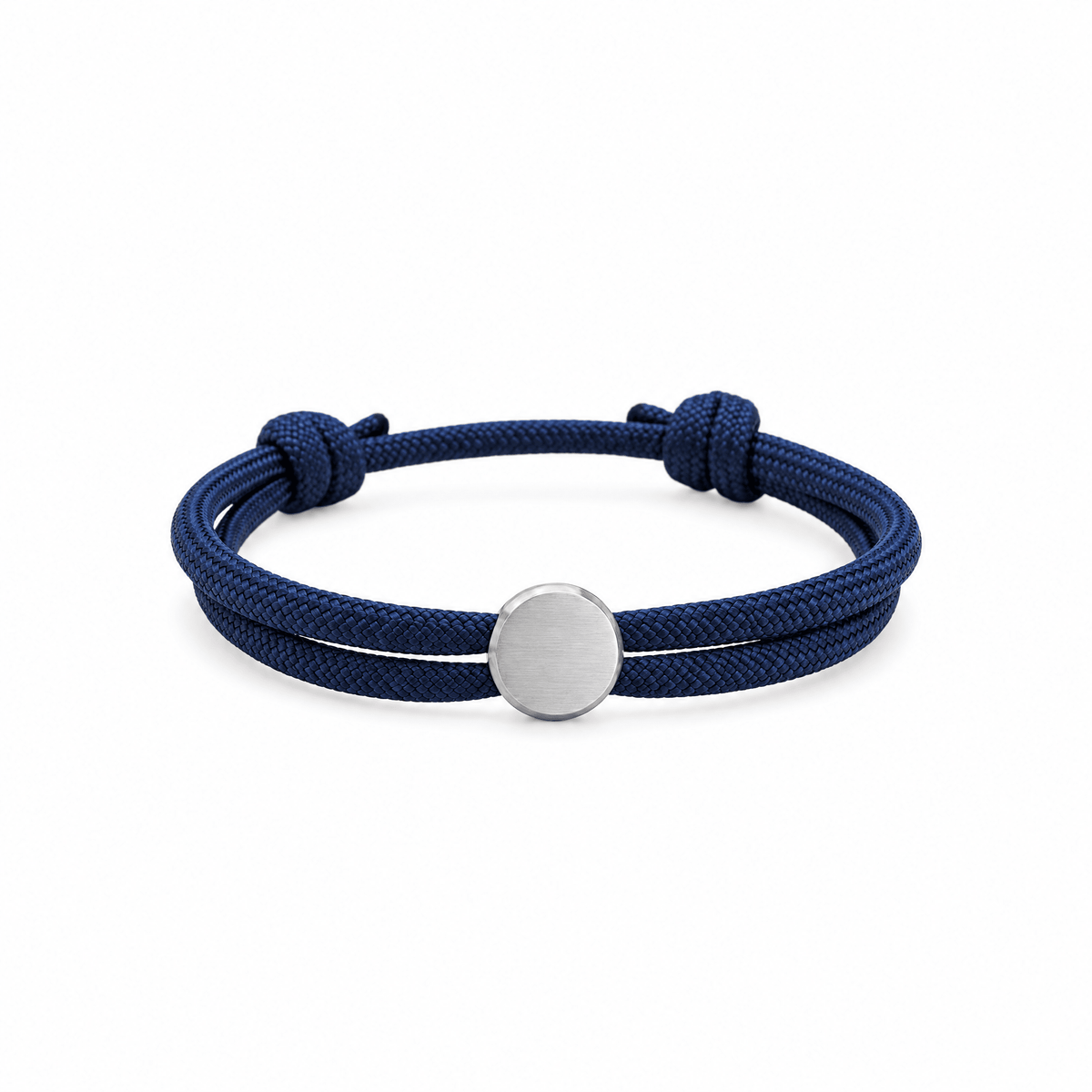Bracelet Marsin Bleu marine et argent, cordon ajustable et pastille ronde, posé de face sur fond blanc
