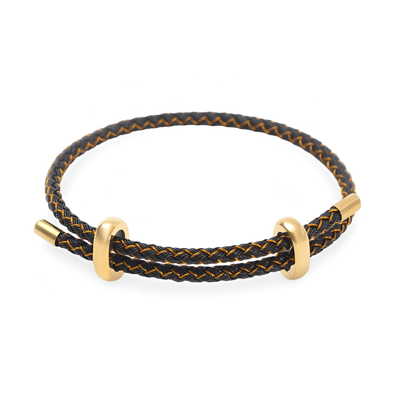 Bracelet cordon noir tressé avec anneaux et fermoir en acier inoxydable doré.