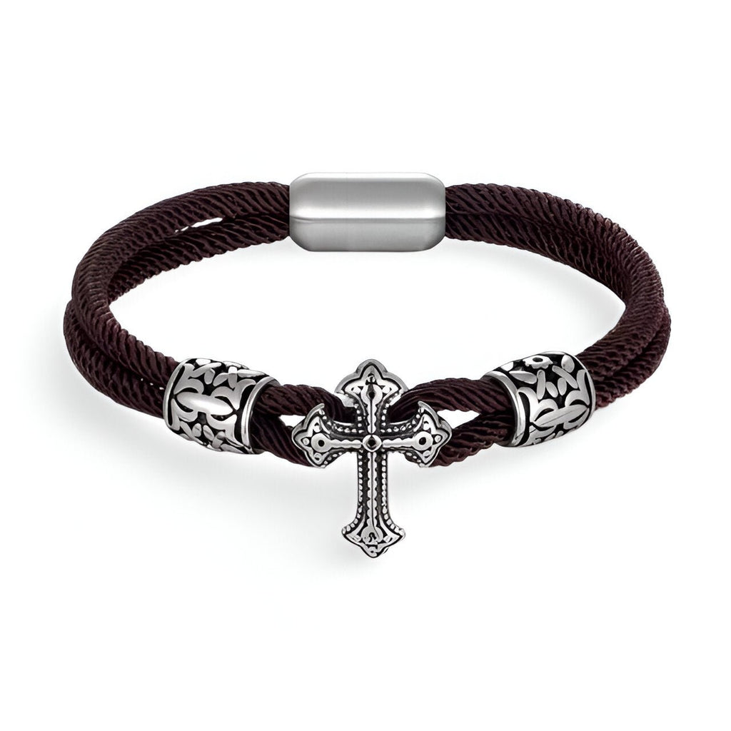 Bracelet cordon coton café avec croix chrétienne en acier inoxydable et fermoir magnétique.
