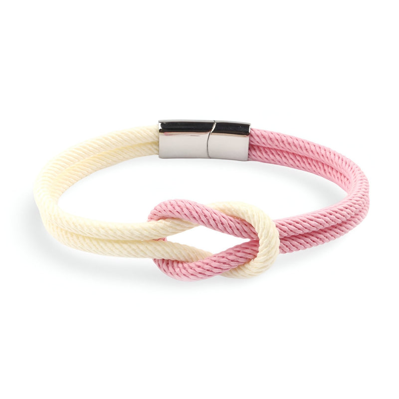 Bracelet cordon bi-colore rose et blanc avec noeud et fermoir métallique argenté.