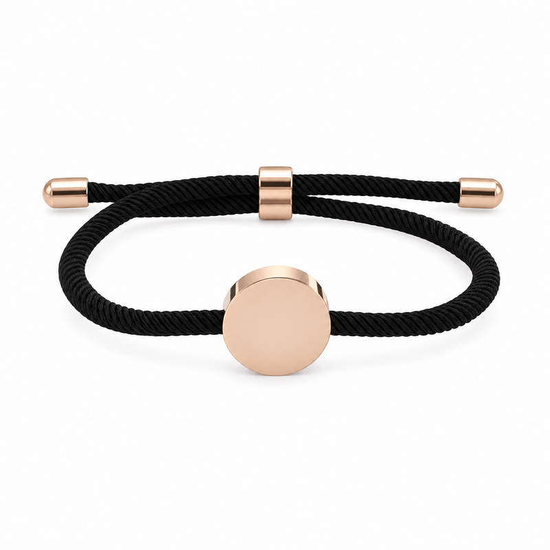 Bracelet Dax Or rosé / Noir, cordon ajustable et médaillon rond, posé de face sur fond blanc