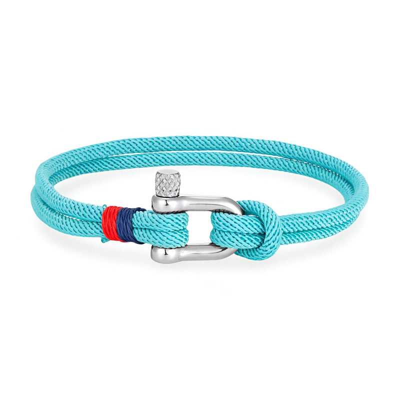 Bracelet cordon turquoise avec manille en acier inoxydable et détail rouge et bleu.