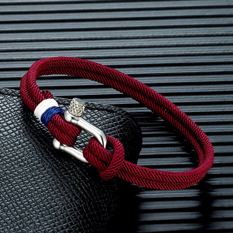 Bracelet cordon rouge bordeaux pour homme avec manille en acier inoxydable et détail tricolore bleu blanc rouge.