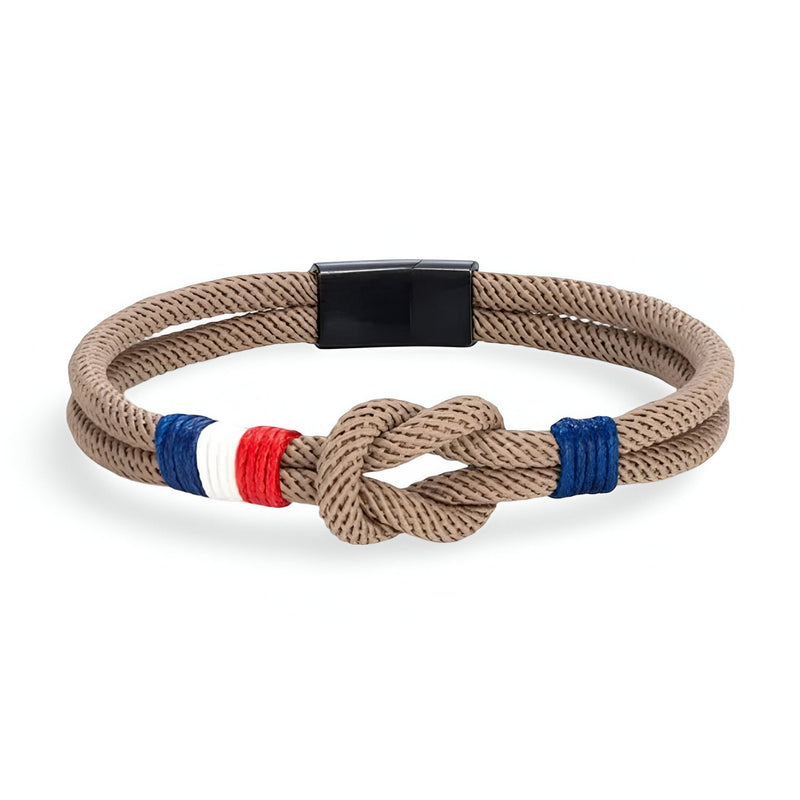 Bracelet cordon beige avec noeud et détail tricolore bleu blanc rouge, fermoir noir mat.