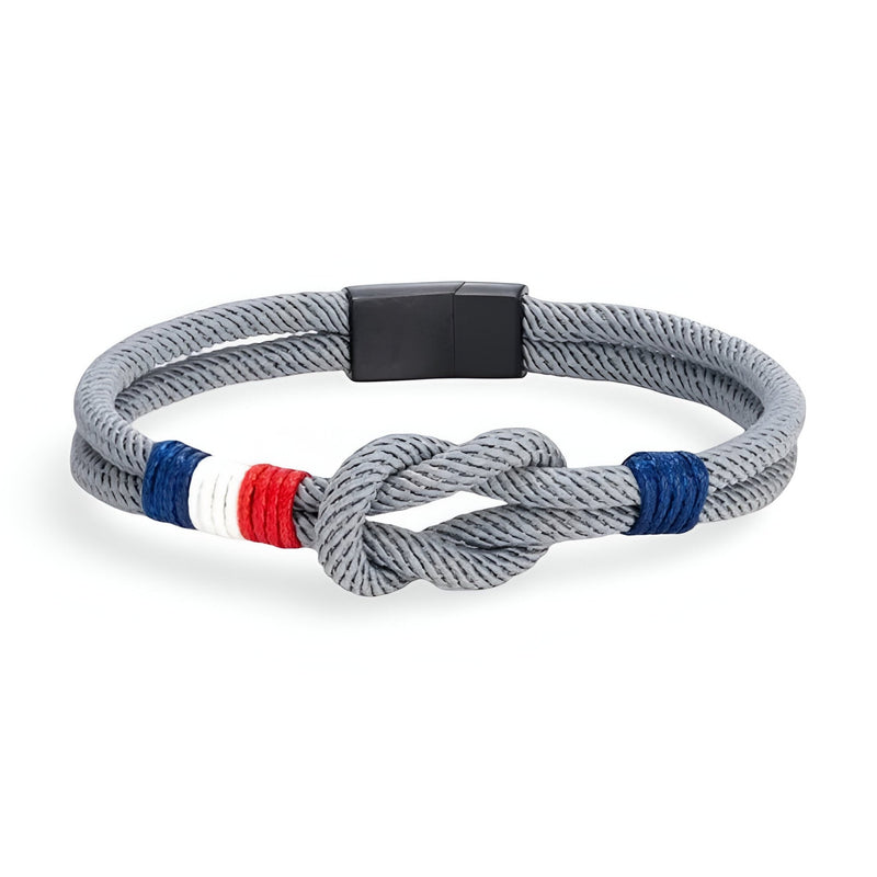 Bracelet cordon gris foncé avec nœud central et détails bleu, blanc, rouge, fermoir noir mat.