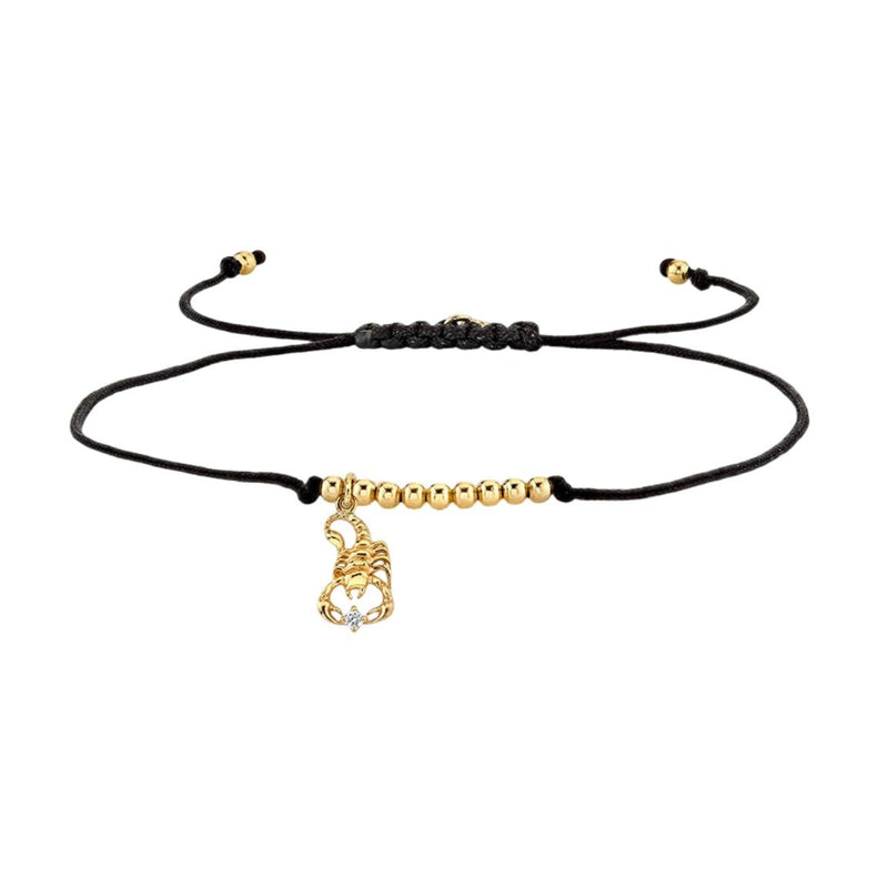 Bracelet cordon noir avec perles dorées et pendentif signe zodiaque Bélier en métal doré.