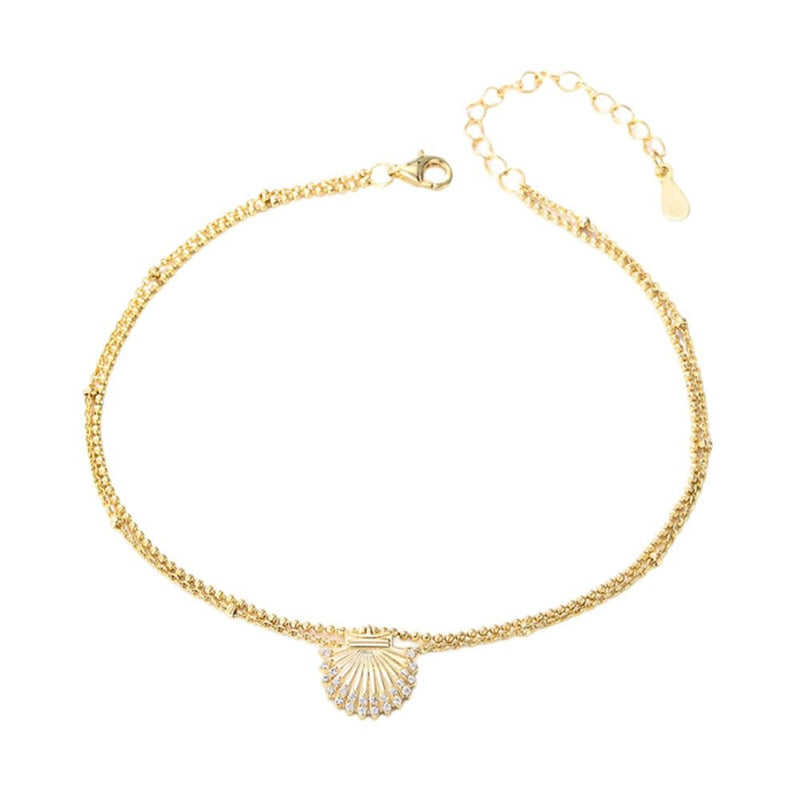 Bracelet de cheville doré en argent sterling avec pendentif coquillage marine délicat.