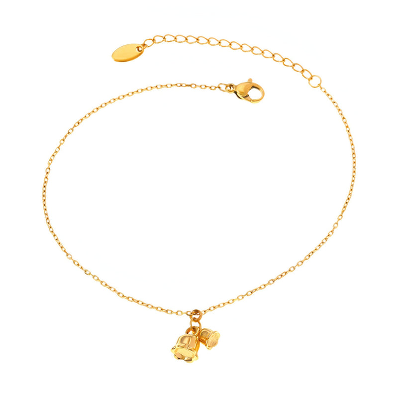 Bracelet de cheville fin en titane doré avec pendentifs cloches délicats.