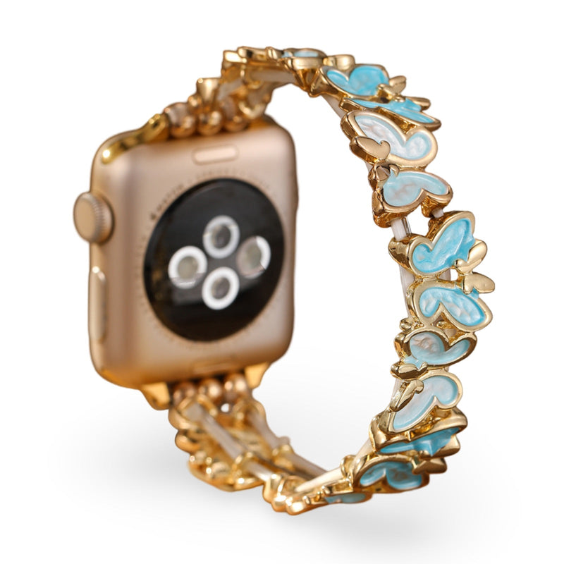Bracelet Apple Watch pour femme avec motif papillons bleus en métal doré, modèle Florencia.