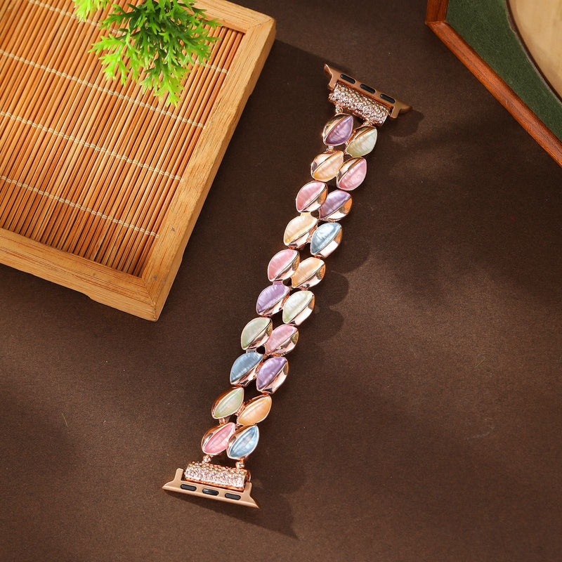 Bracelet Apple Watch femme modèle Raquel avec pétales scintillants multicolores et attache rose.