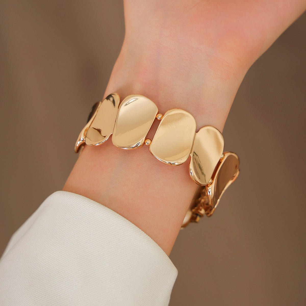 Bracelet Apple Watch femme Lidia en alliage métallique doré avec maillons larges et brillants.
