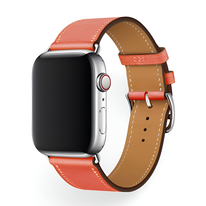 Bracelet Apple Watch en cuir orange vif avec surpiqûres blanches, boucle argentée, intérieur marron clair.
