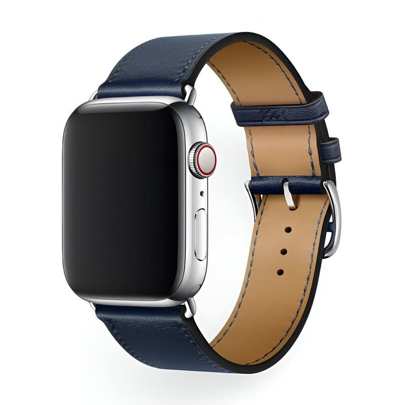 Bracelet Apple Watch en cuir bleu nuit, intérieur beige, boucle argentée, style classique mixte.