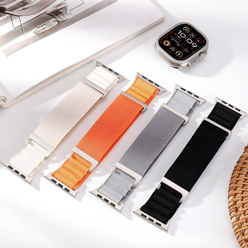 Bracelets Apple Watch en nylon à boucle alpine, couleurs blanc, orange, gris et noir, tailles variées.