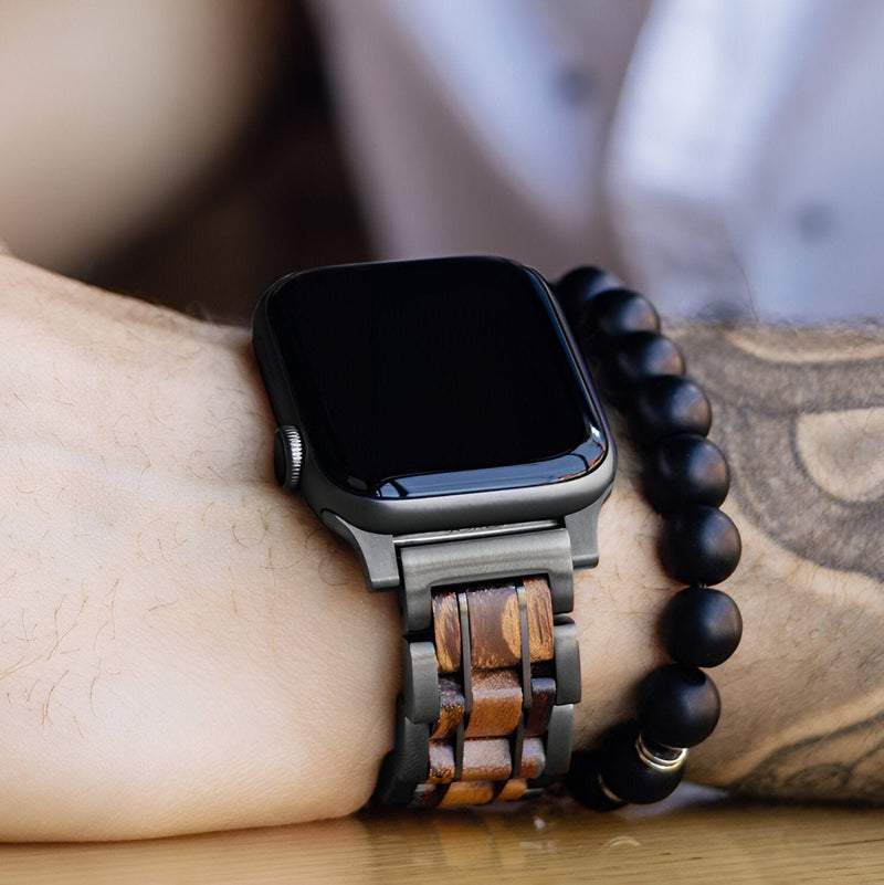 Bracelet de montre Apple Watch en bois de Zébrano avec maillons alternés et finition naturelle, porté au poignet homme.