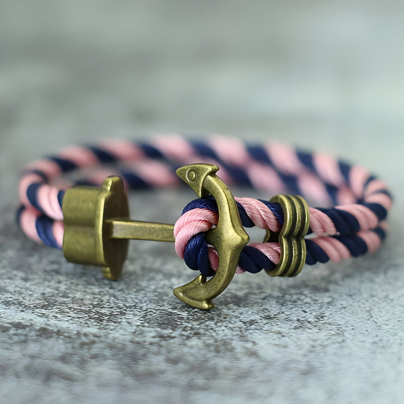 Bracelet double cordon rose et bleu avec motif ancre antique en métal bronze.