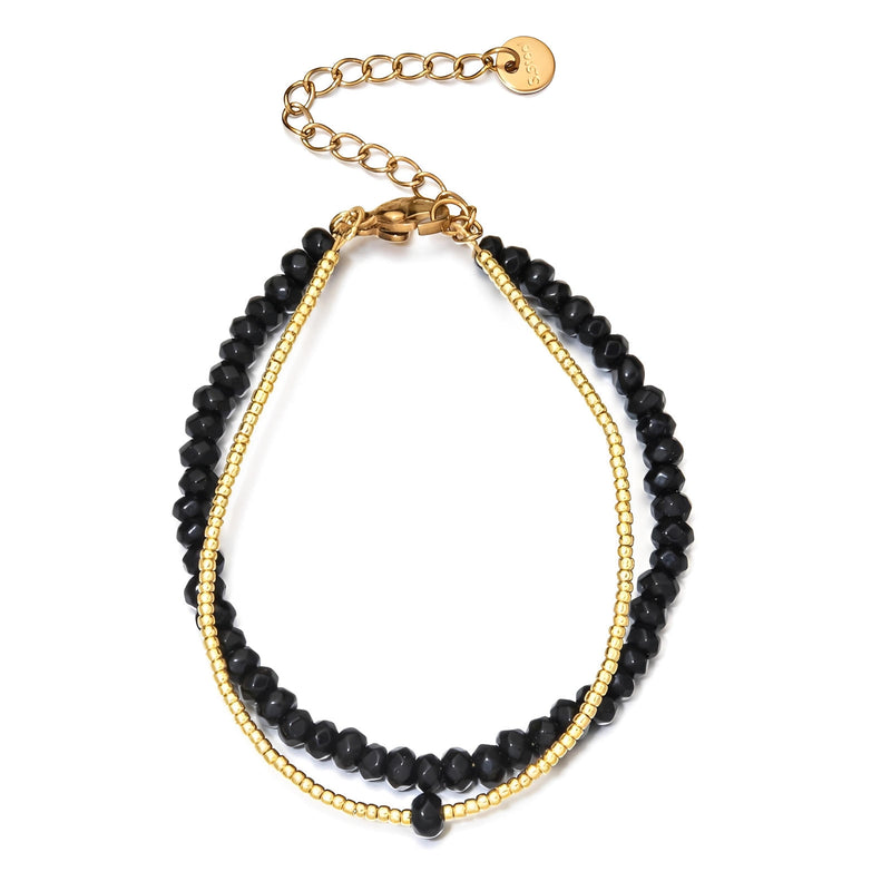Bracelet double rang avec perles naturelles facettées noires et fines billes dorées, fermoir chaîne ajustable.
