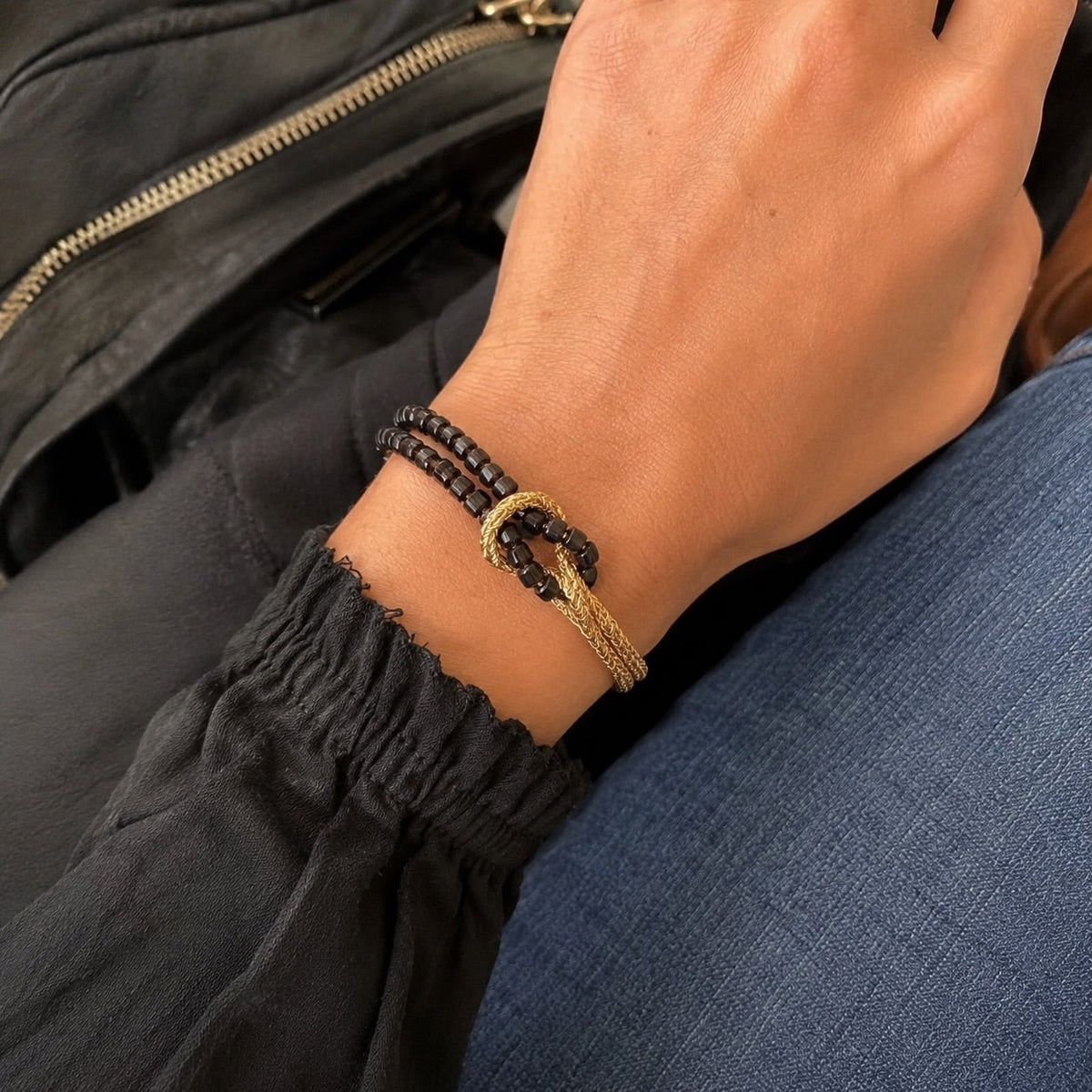 Double-strand bracelet with natural stones, twisted golden cord, central knot, Idecine model