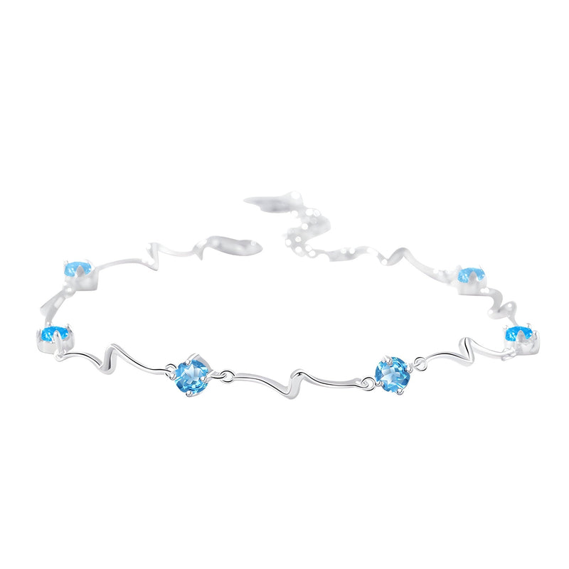 Bracelet en argent sterling avec pierres bleues sur chaîne ondulée élégante.