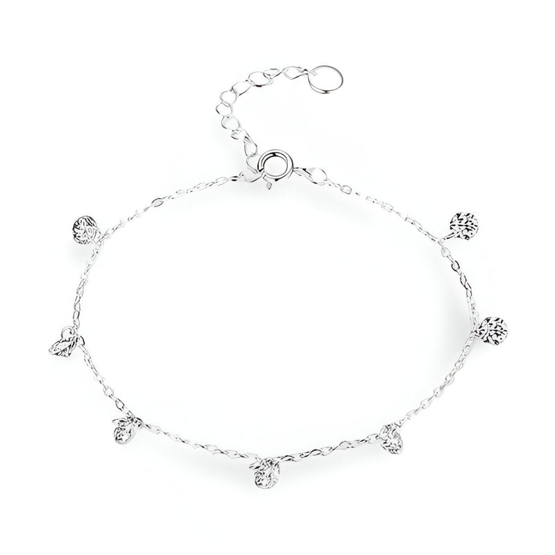 Bracelet fin en argent sterling avec petites breloques rondes serties de zircons délicats.