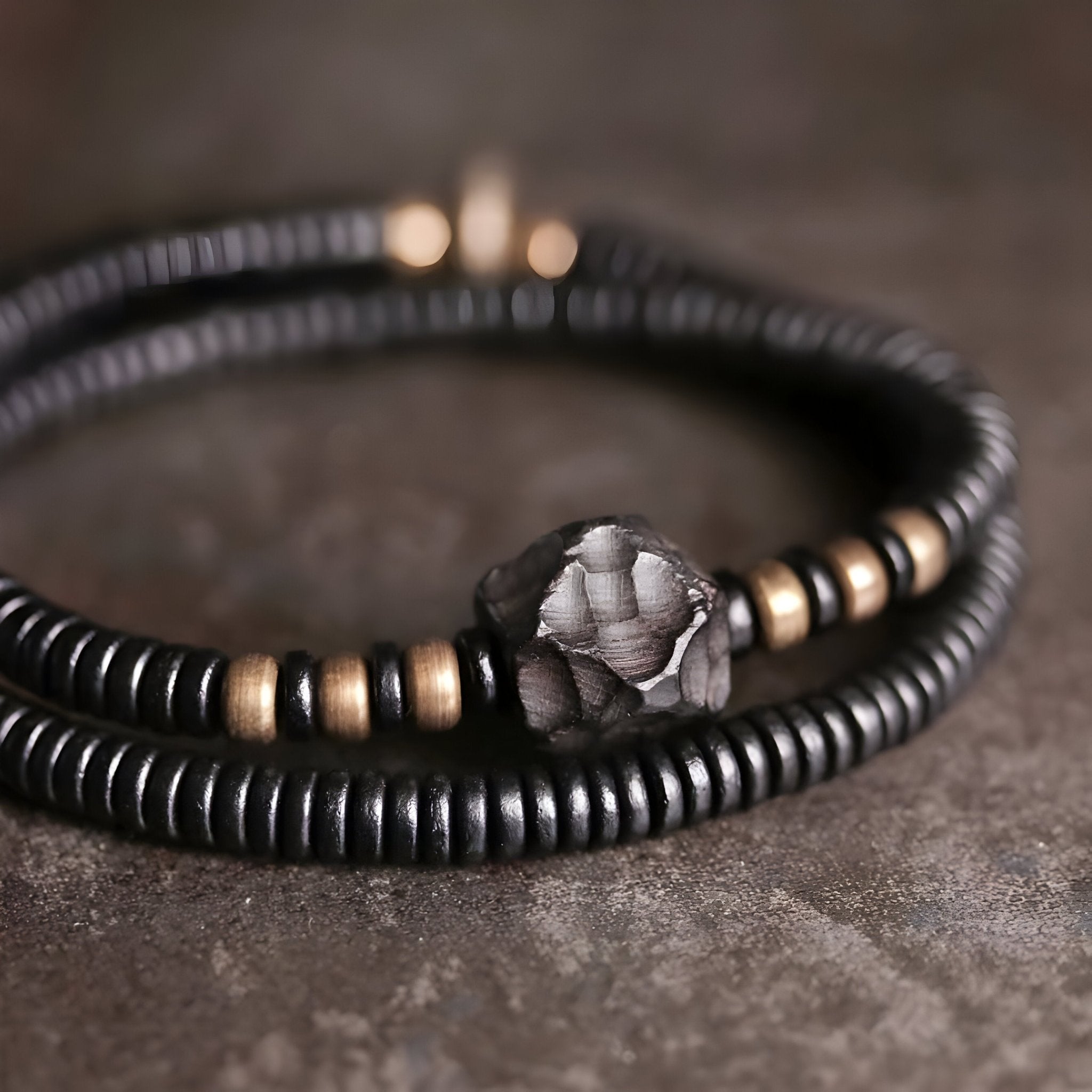 Bracelet femme en bois d'ébène noir à perles plates, détail perle centrale en cuivre martelé.