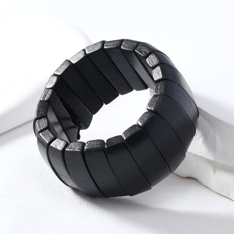 Bracelet femme en bois naturel noir avec maillons larges et design épuré.