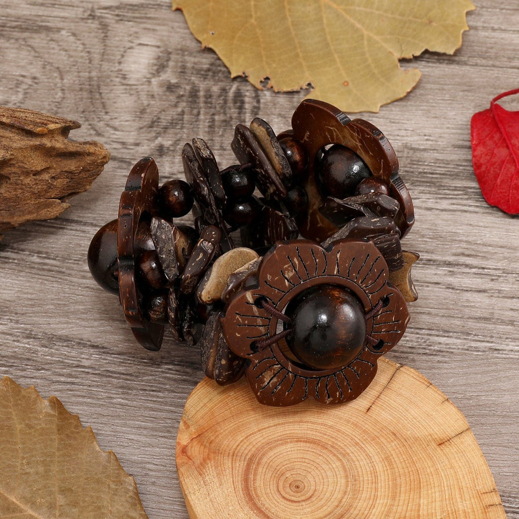 Bracelet en bois naturel couleur café avec fleurs sculptées et perles rondes noires.