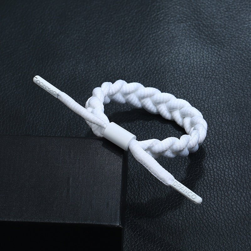 Bracelet tressé en corde blanche avec fermoir cylindrique, style simple et moderne.