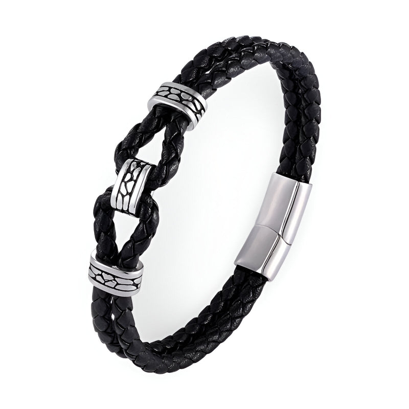 Bracelet homme en cuir noir tressé avec nœud et fermoir magnétique argenté orné de détails gravés.