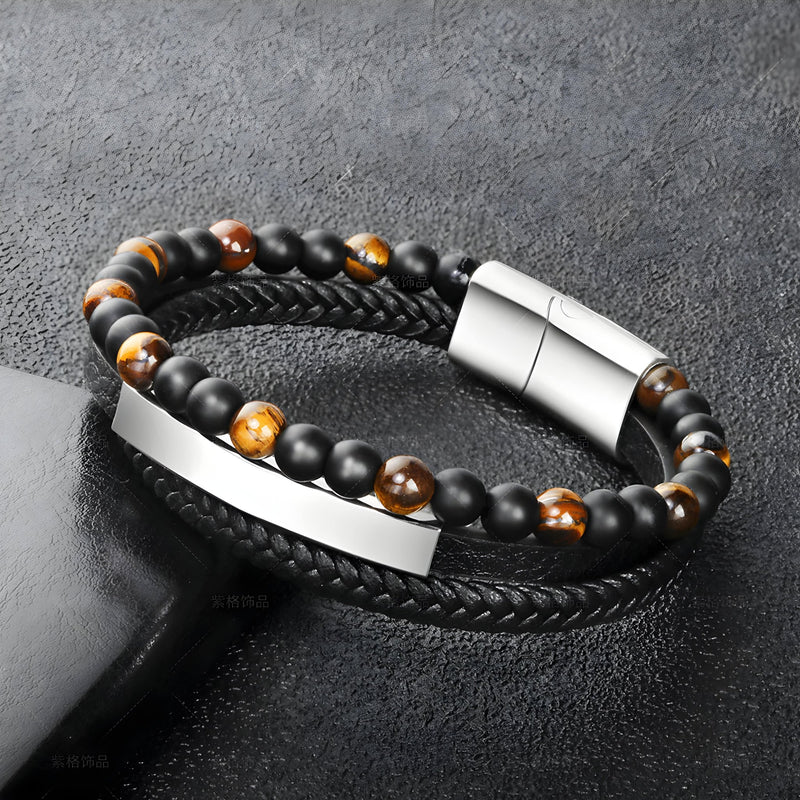 Bracelet en cuir noir tressé et perles œil de tigre marron avec fermoir et plaque en acier inoxydable argenté.