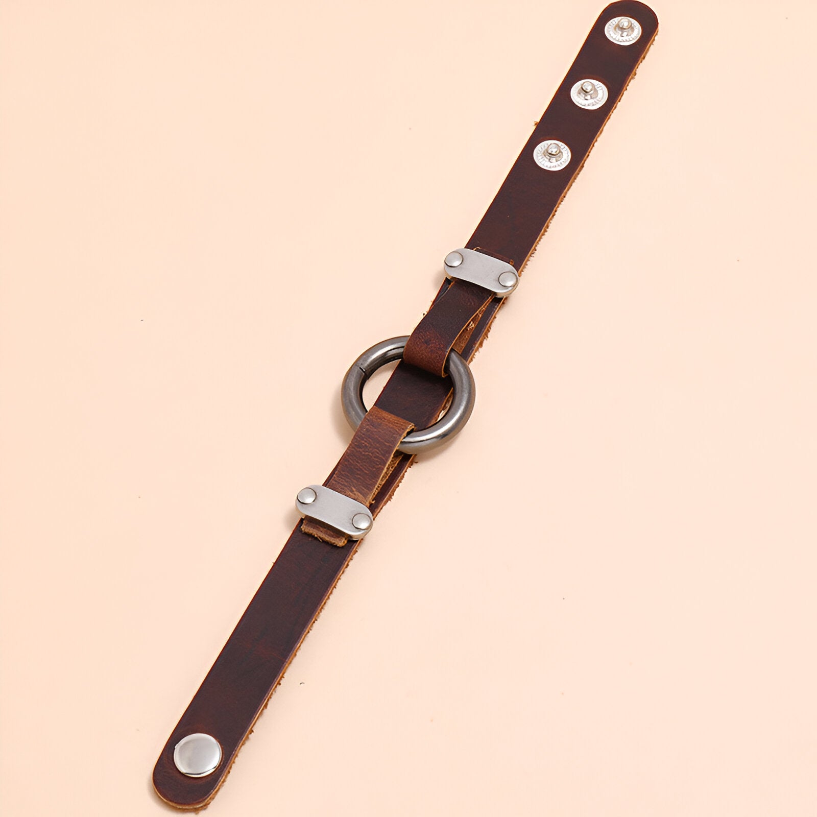 Bracelet homme en cuir marron avec anneau métallique et fermoirs argentés.