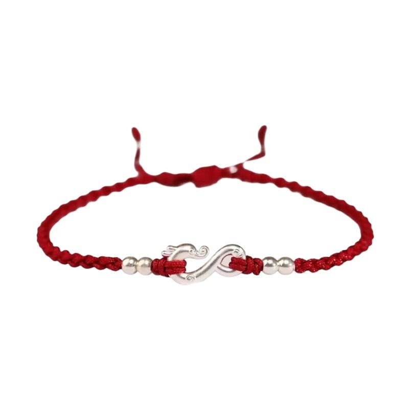 Bracelet rouge en fil ciré avec pendentif infini en métal argenté et perles brillantes.