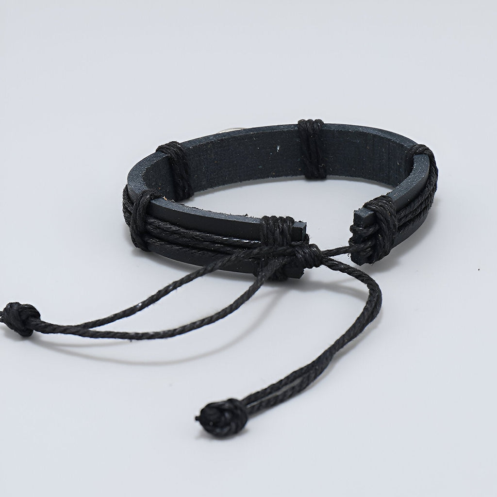 Bracelet en microfibre noir avec design de ballon de rugby, fermeture réglable par cordon.