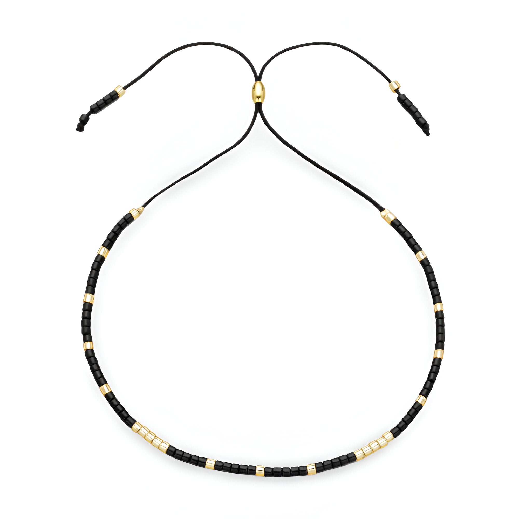 Bracelet Tsunada pour femme en perles noires et dorées sur cordon noir réglable.