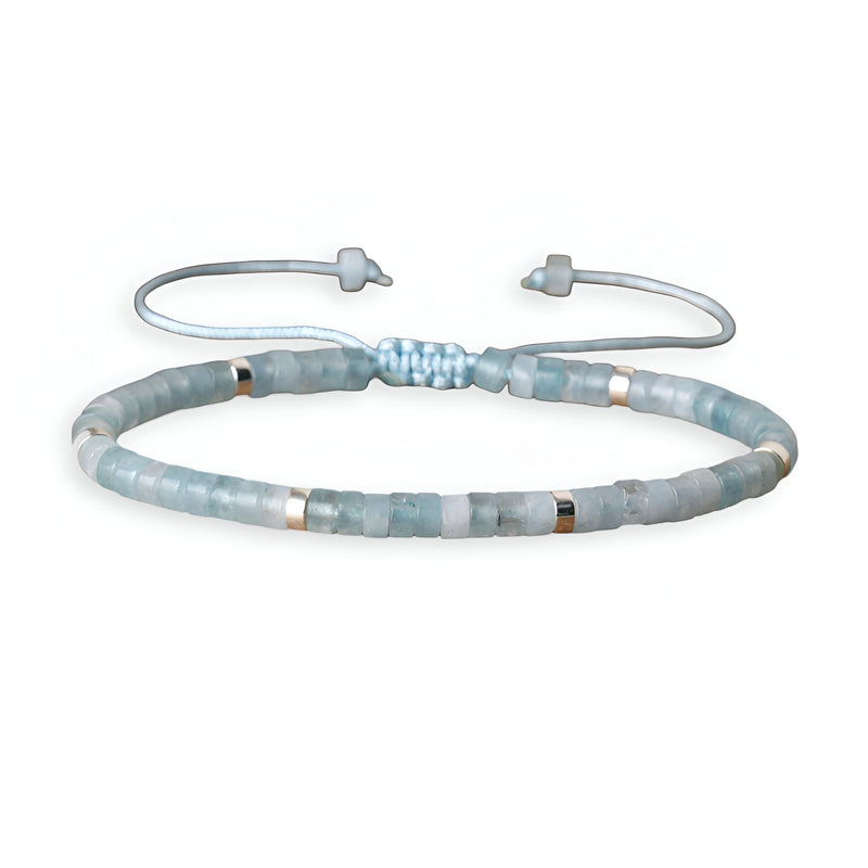 Bracelet mixte perles heishi en aigue-marine bleu clair avec fermoir ajustable en coton tressé.