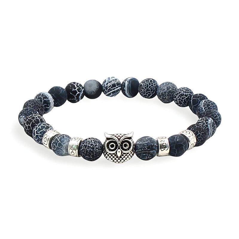 Bracelet mixte en pierres volcaniques noires avec hibou protecteur argenté au centre.