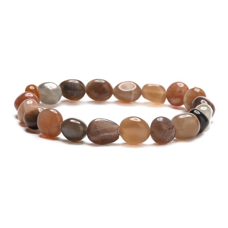 Bracelet asymétrique en pierres naturelles marron et beige avec perles rondes lisses et accents métalliques noirs.