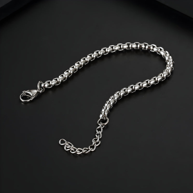 Bracelet en titane argenté maille vénitienne avec fermoir mousqueton et chaînette d’extension.