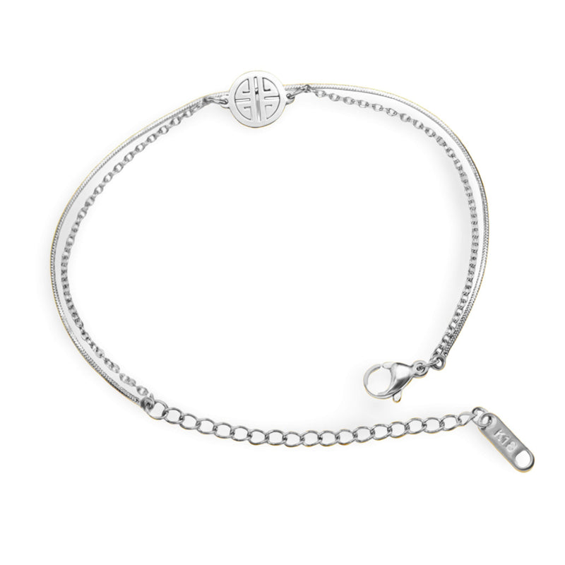 Bracelet en titane argenté avec chaîne fine et médaillon géométrique rond au fermoir mousqueton.