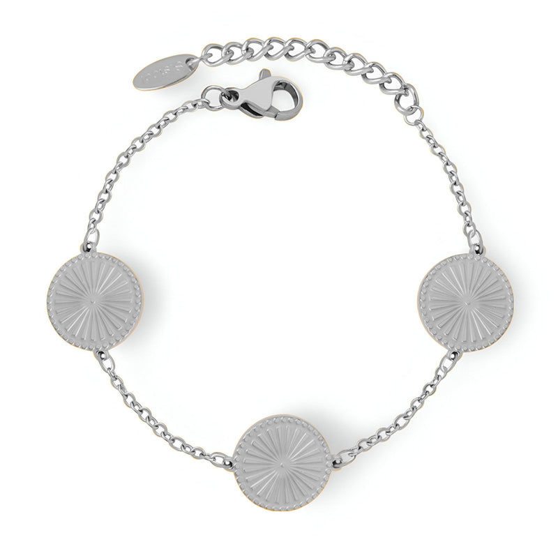 Bracelet en titane argenté avec trois médaillons ronds rayonnants et chaîne fine ajustable.