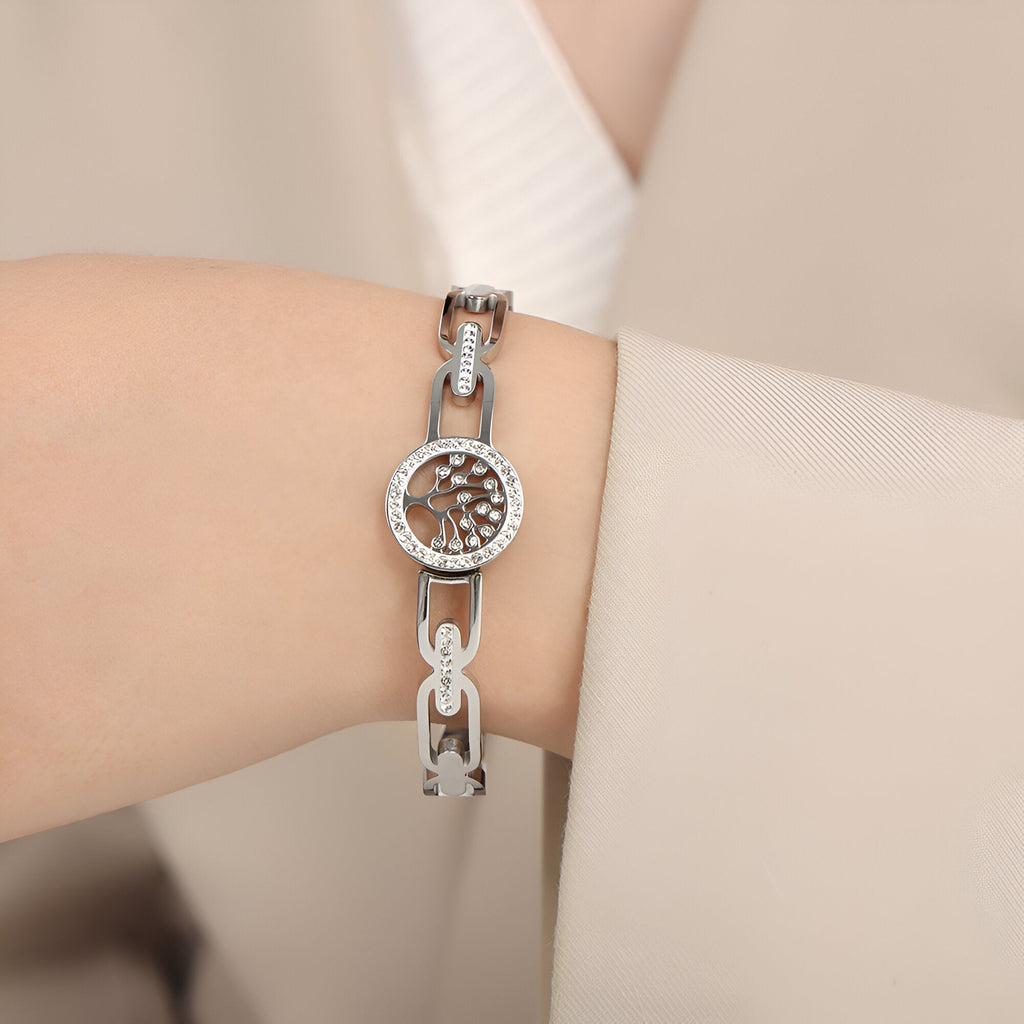 Bracelet en titane argenté pour femme avec motif arbre de vie et strass scintillants autour du cadran rond.