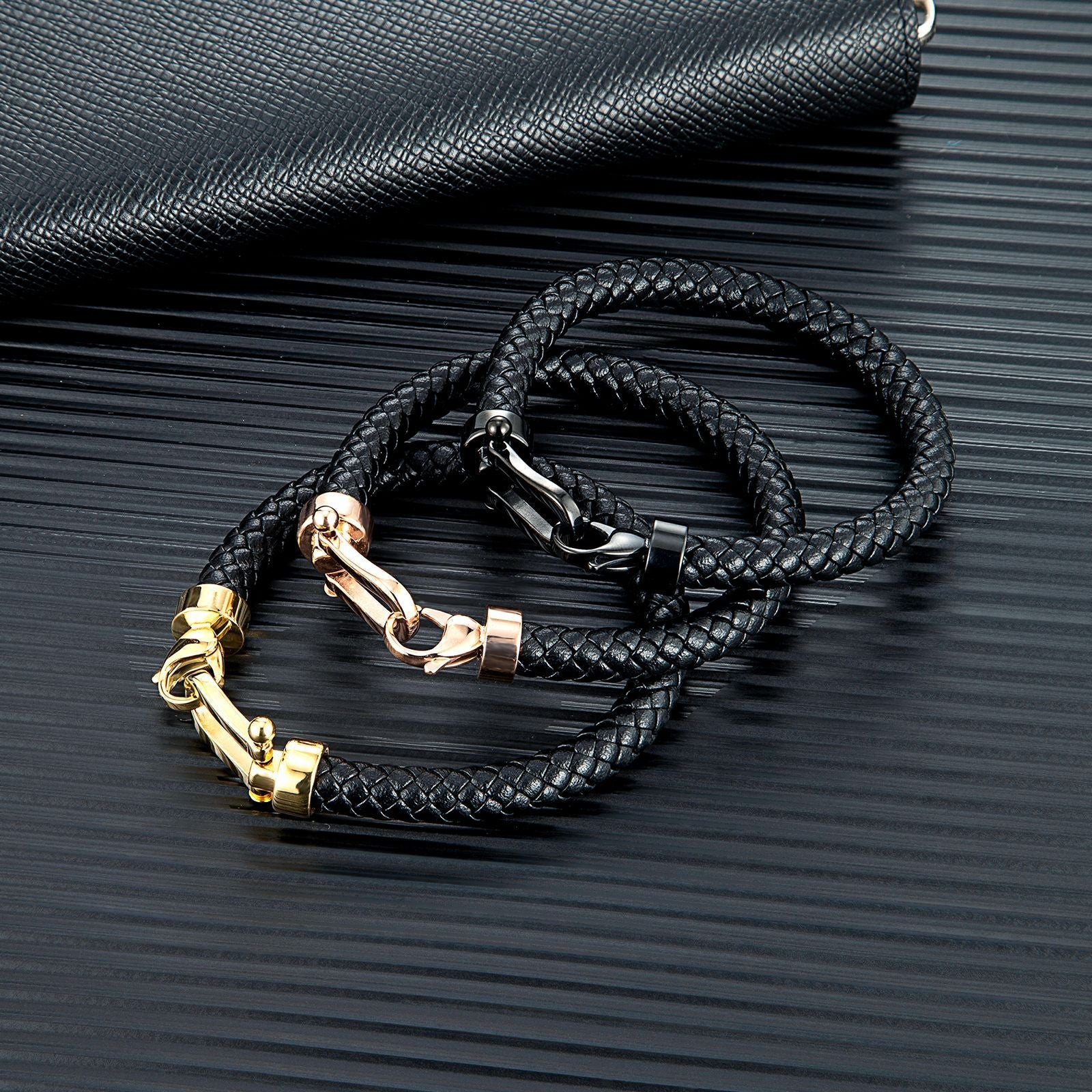 Bracelets homme en cuir tressé noir avec fermoirs fer à cheval en acier inoxydable or, argent et or rosé.