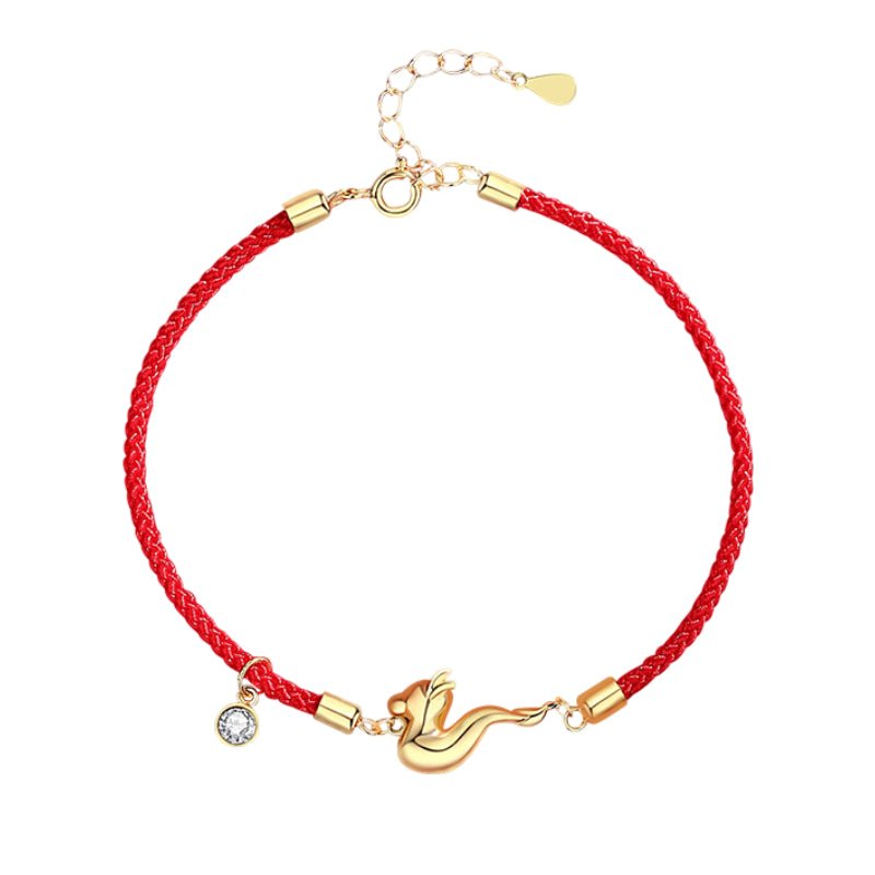 Bracelet tressé rouge avec breloque dragon dorée et pendentif cristal clair.